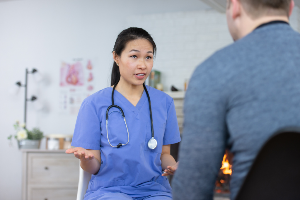 nurse speaking with male patient on when to go to the hospital for anxiety