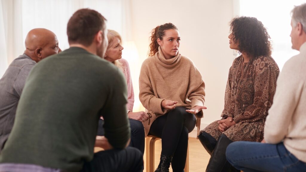 woman sitting with a group of clients discussing the alternatives to xanax