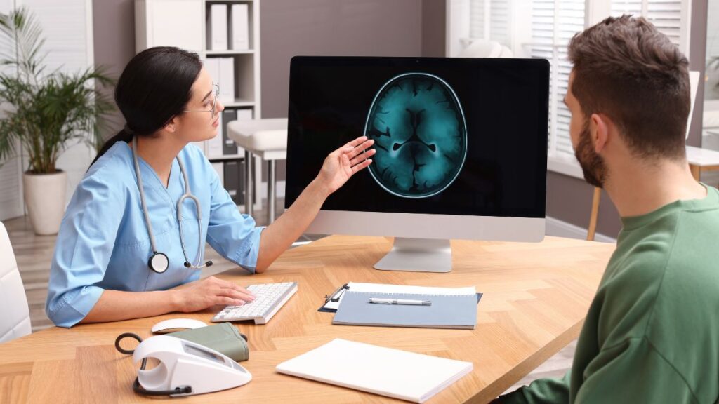 doctor going over the progress of a patients brain scan with tms vs ect