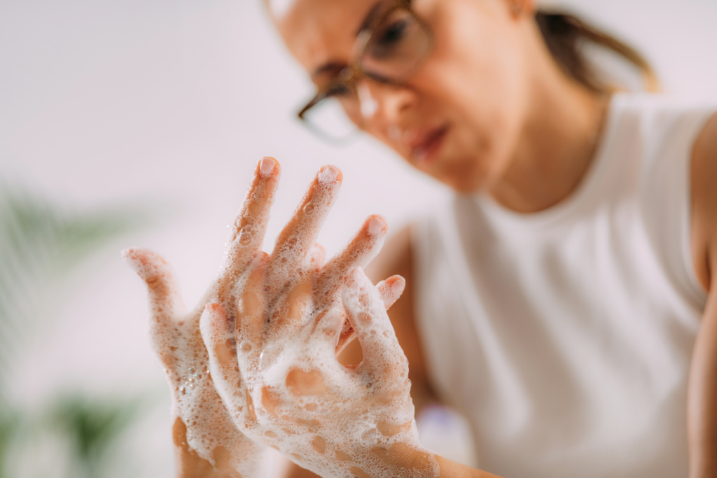 woman struggling with wondering if is OCD genetic while compulsively washing her hands